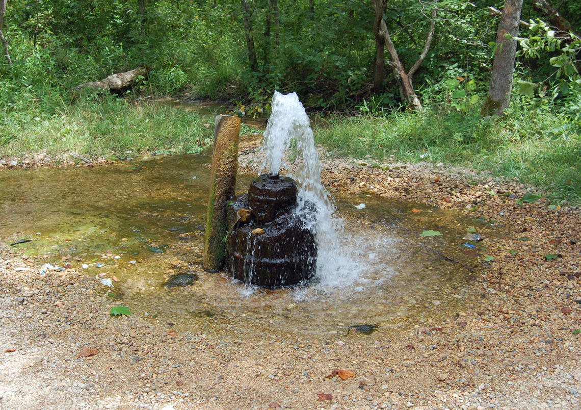 A well with water flowing out the top.